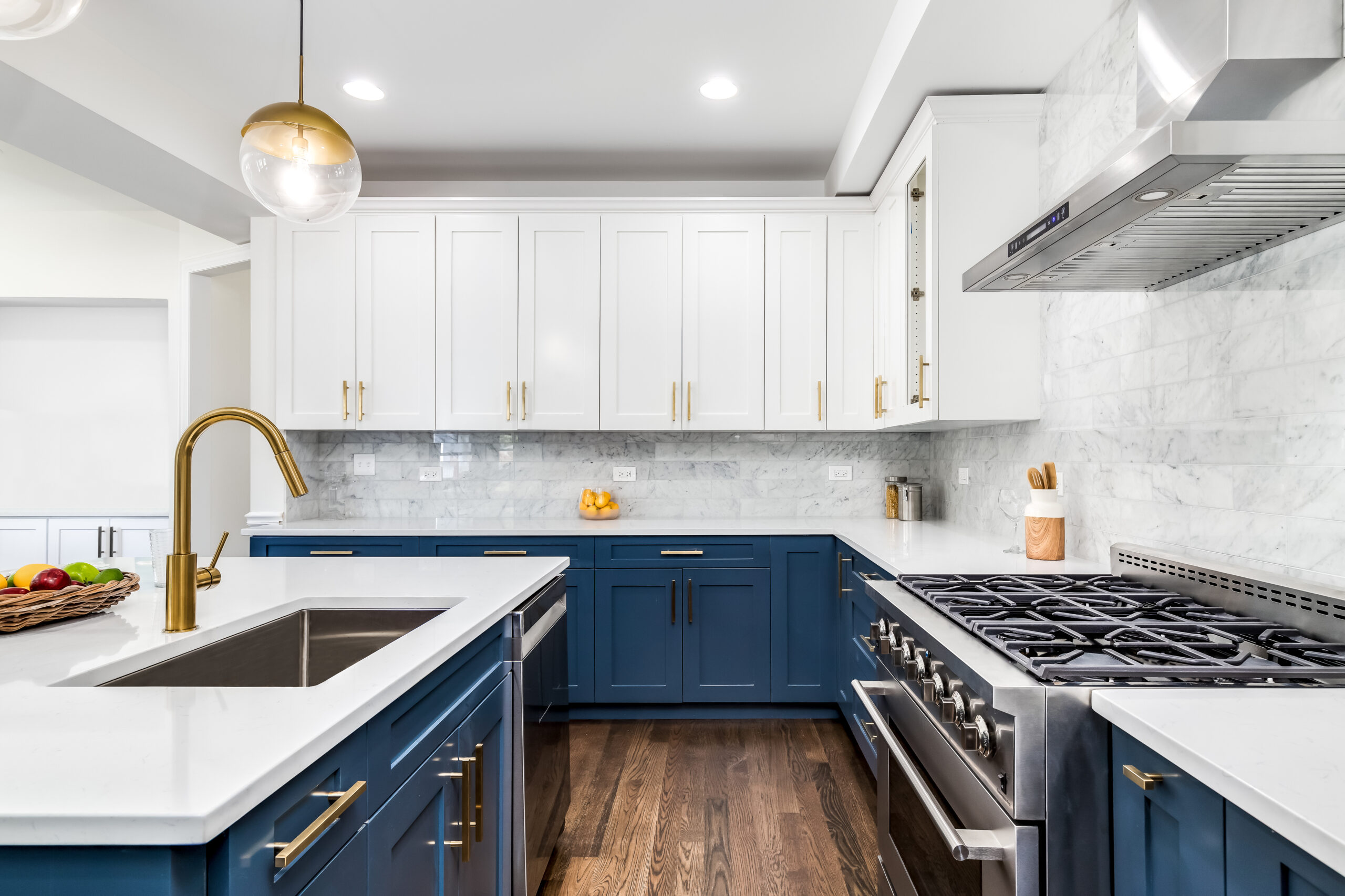 A luxurious white and blue kitchen with gold hardware, stainless steel appliances, and white marbled granite countertops. No brands or labels. Property Inspections in Peoria, AZ